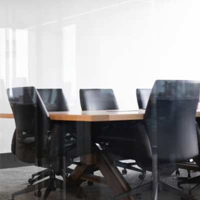 Black chairs surrounding a table with white walls