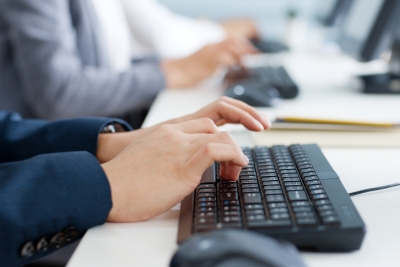 hands typing on a computer keyboard