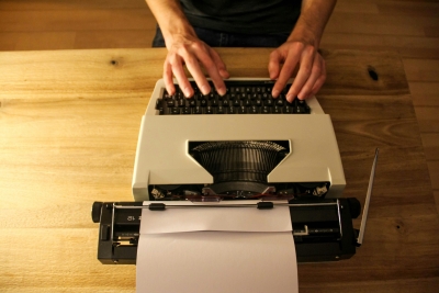 Typewriter with hands typing