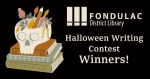 Halloween Writing Contest Winners; Skull shaped pencil cup on top of stack of books