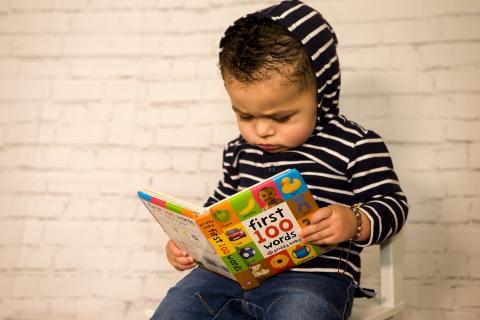 small child reading a book