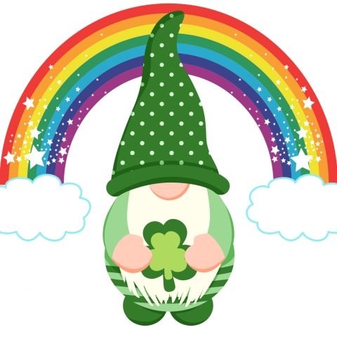 gnome dressed as a leprechaun holding a green shamrock in front of a glittering rainbow