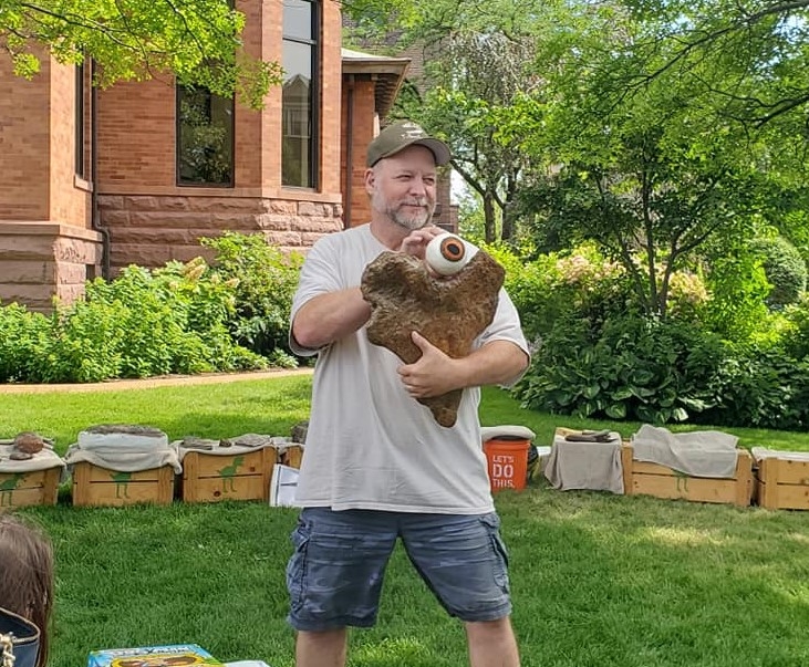 man holding dinosaur bone