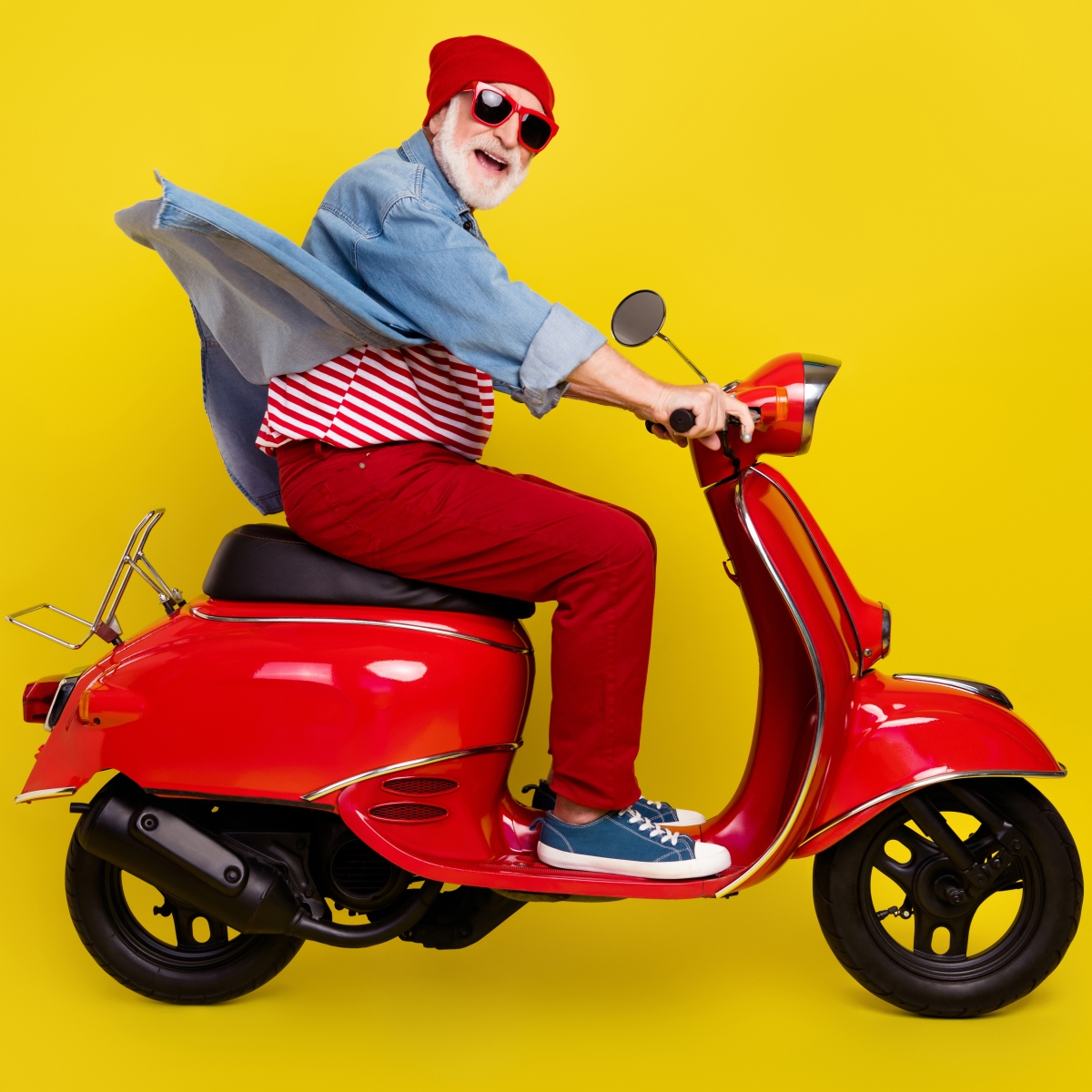 senior citizen having fun, riding a motor scooter