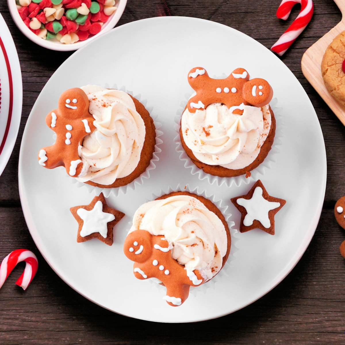 plate of gingerbread men and cupcakes