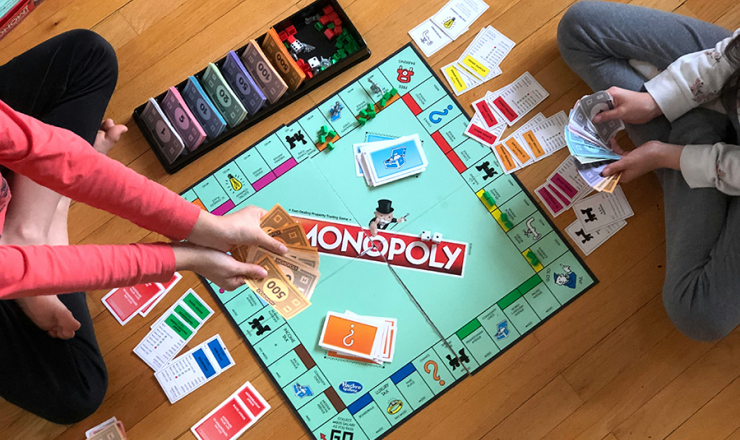 Teens playing Monopoly