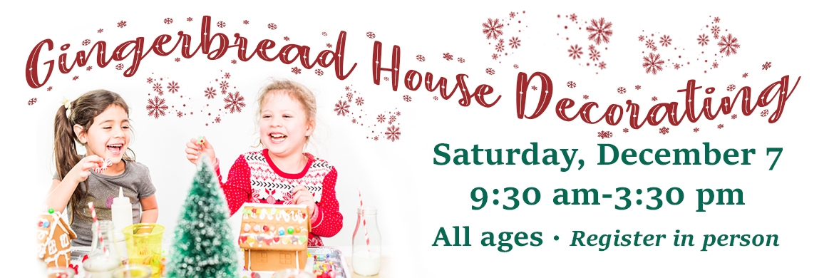 little girls decorating a gingerbread house